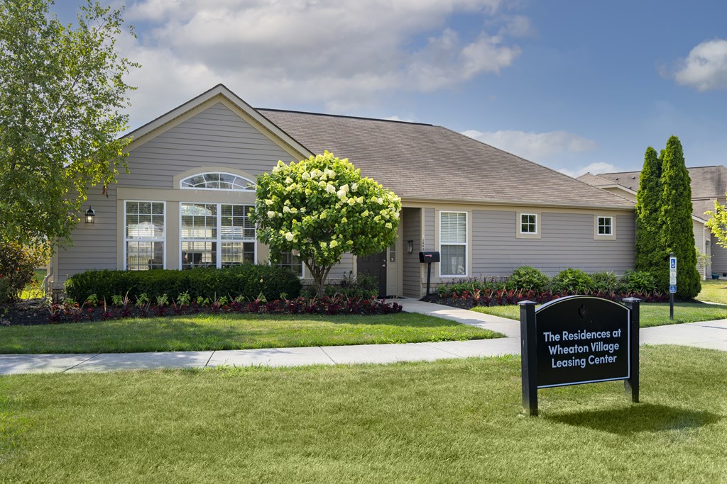 A sign in front of a house that says