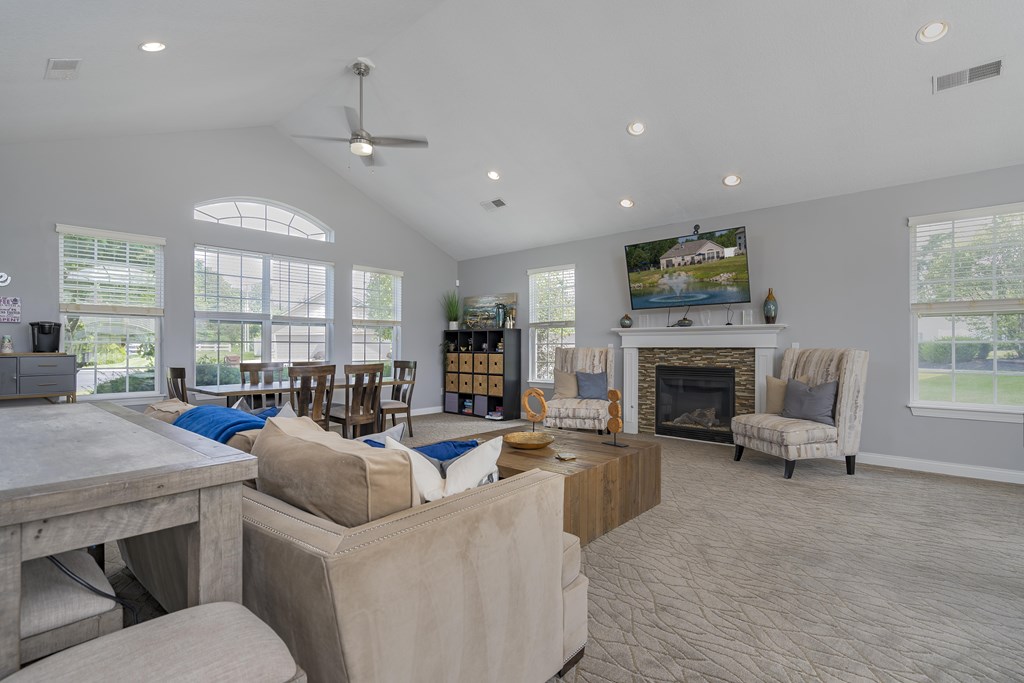 A spacious living room with a fireplace and a television.