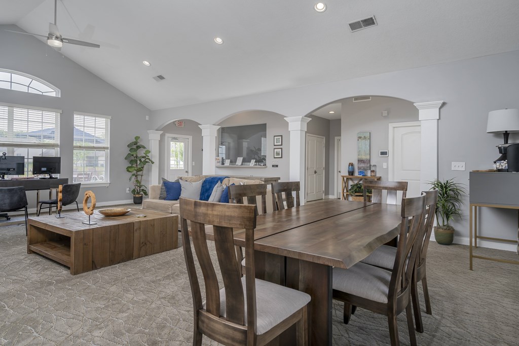 A dining room with a wooden table and chairs.