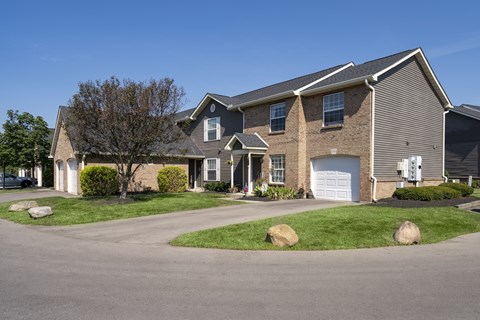 A house with a grey roof and a white garage door.
