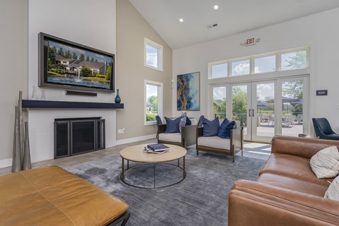 A living room with a fireplace and a painting on the wall.