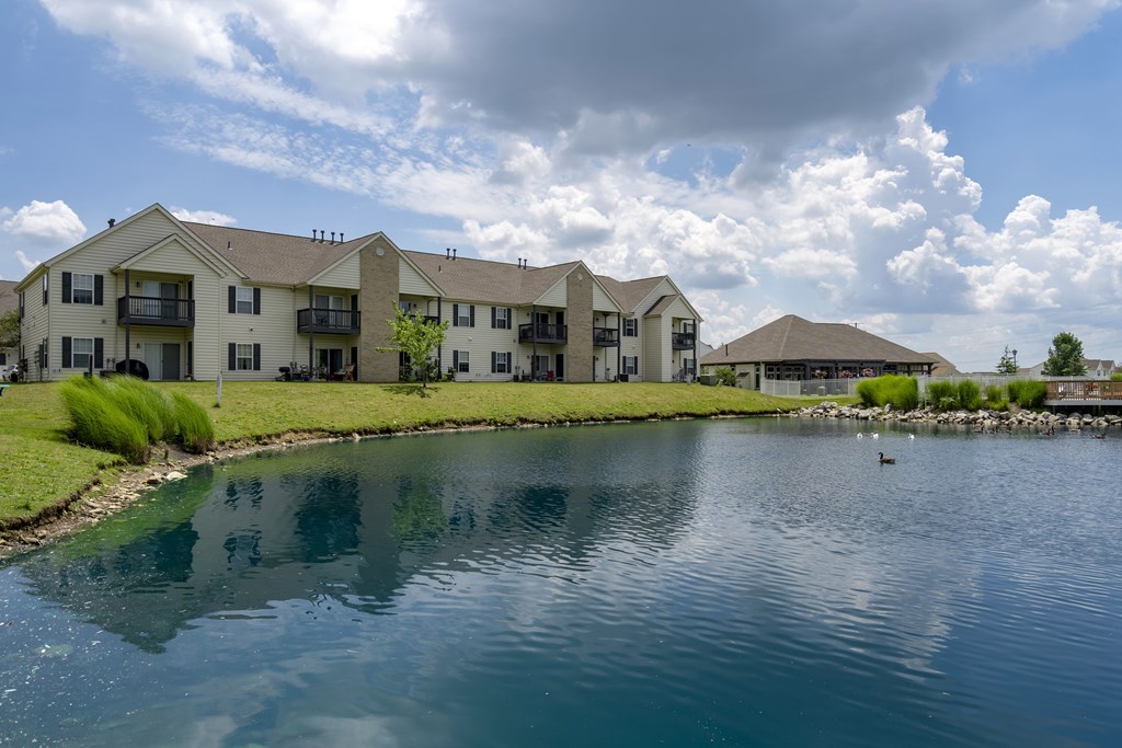 A row of houses with a body of water in front.