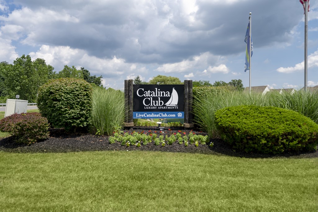 A sign for Catalina Club is displayed in front of a building.