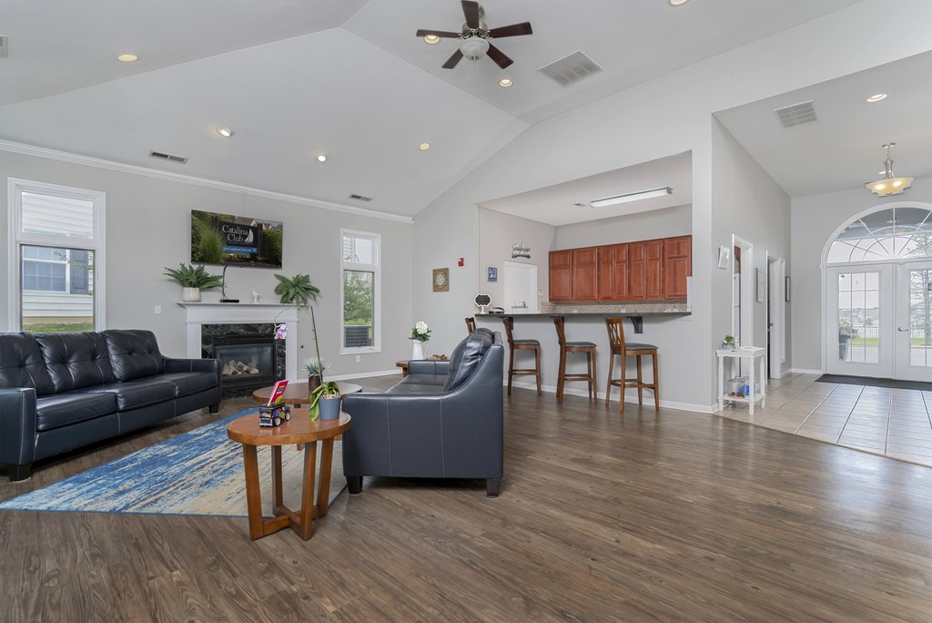 A living room with a fireplace and a TV mounted on the wall.