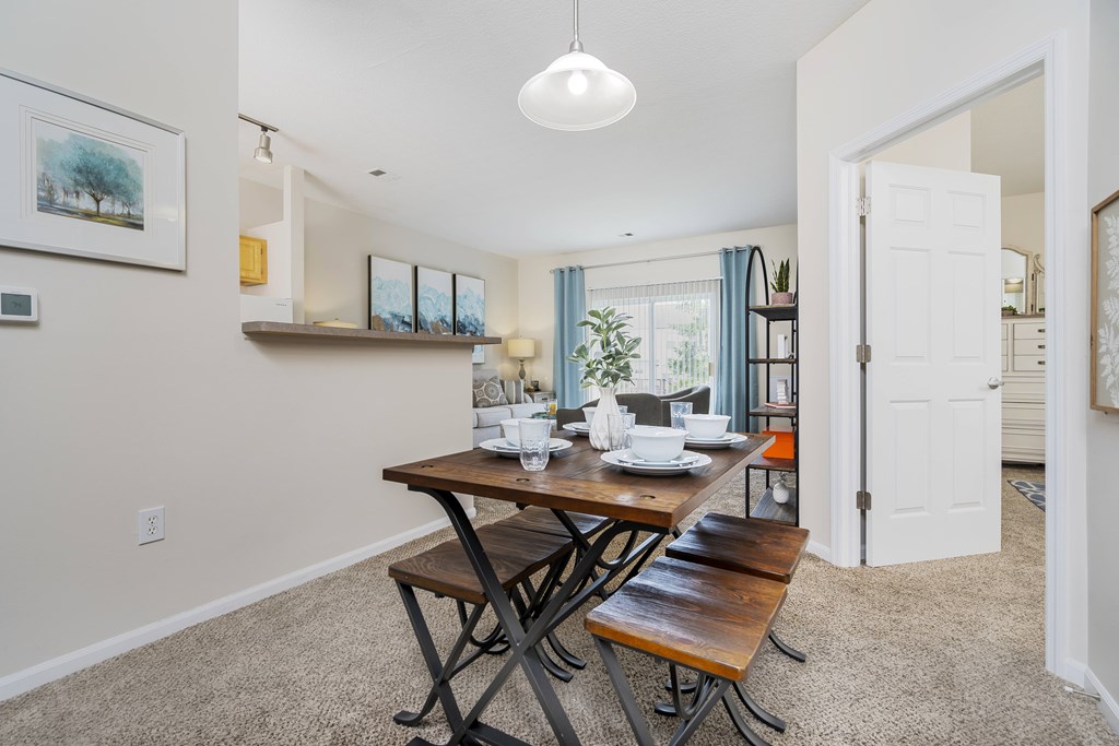 A dining room with a table and chairs.