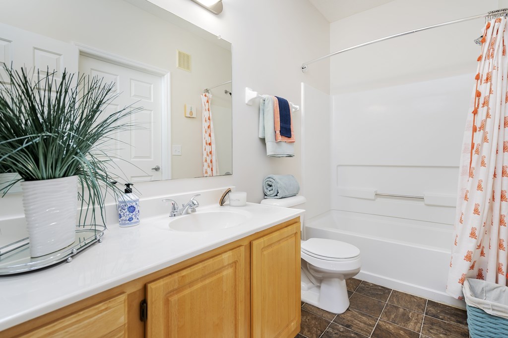 A bathroom with a toilet, sink, and shower.