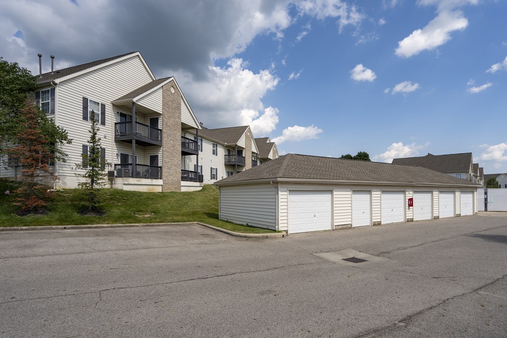 A parking lot with a building and a garage door.