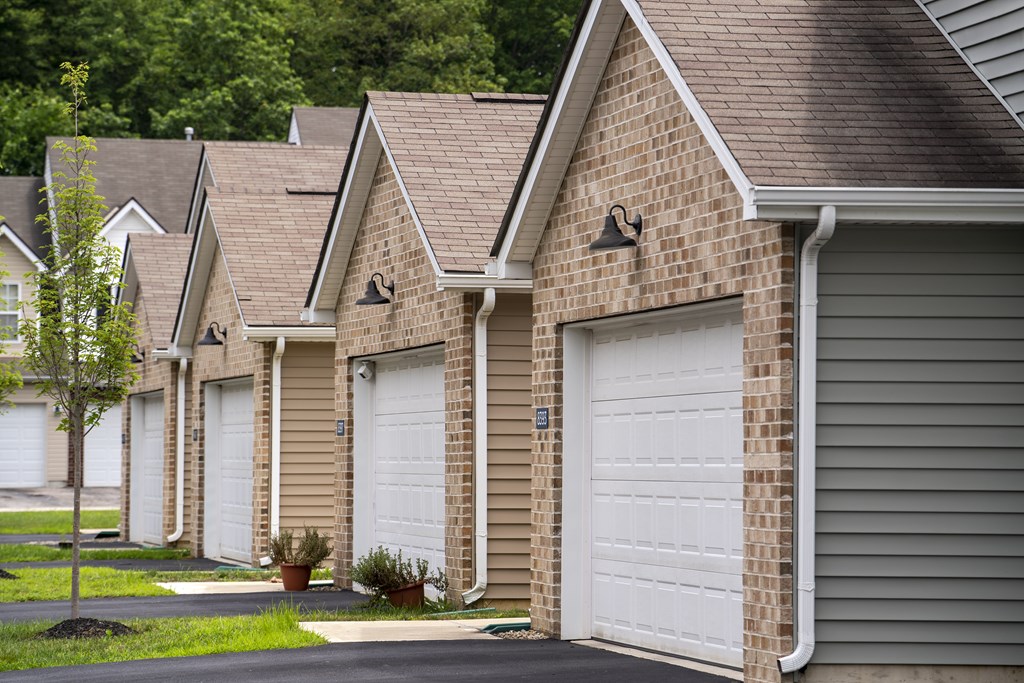 A row of houses with white garage doors.