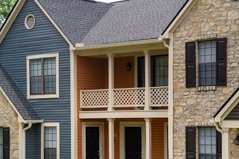 A house with a blue siding and a brown door.