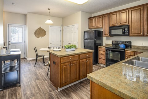 A kitchen with wooden cabinets and a granite countertop.