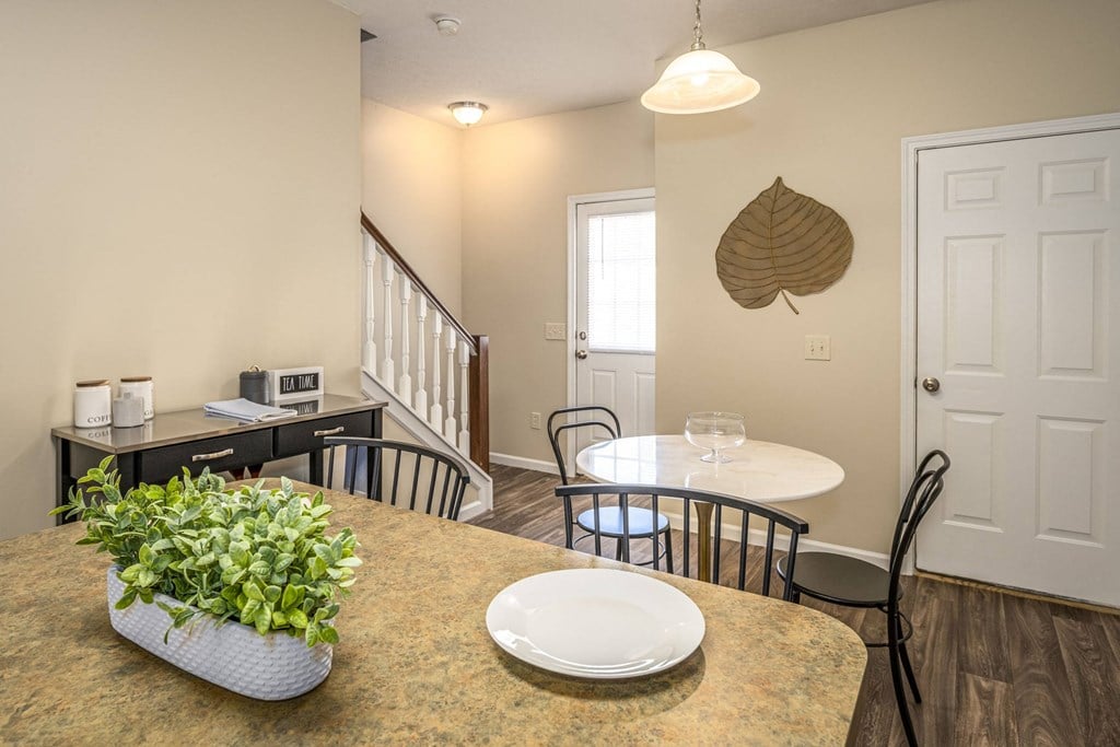 a kitchen and dining room with a table and chairs
