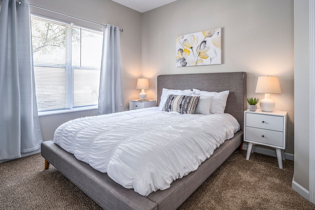 a bedroom with a large bed and a window