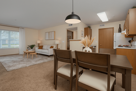 A dining room with a table and chairs.