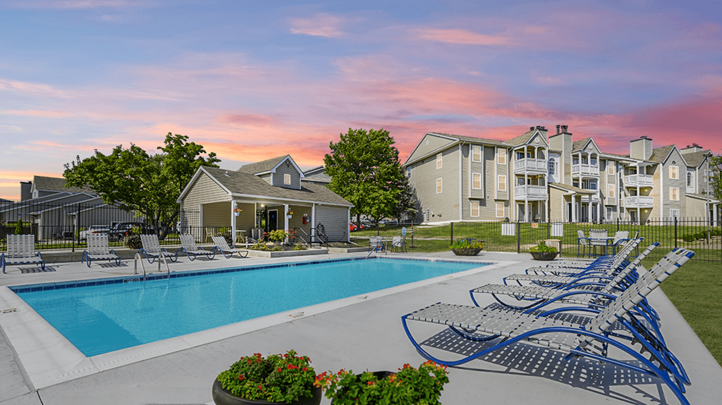 Resort-style pool at The Boulevard in Florence, KY with a sundeck, lush landscaping, and lounge seating