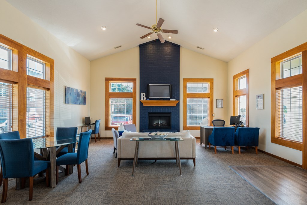 a living room with a fireplace and a table and chairs