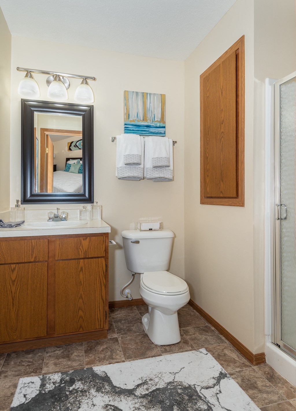 a bathroom with a toilet sink and shower