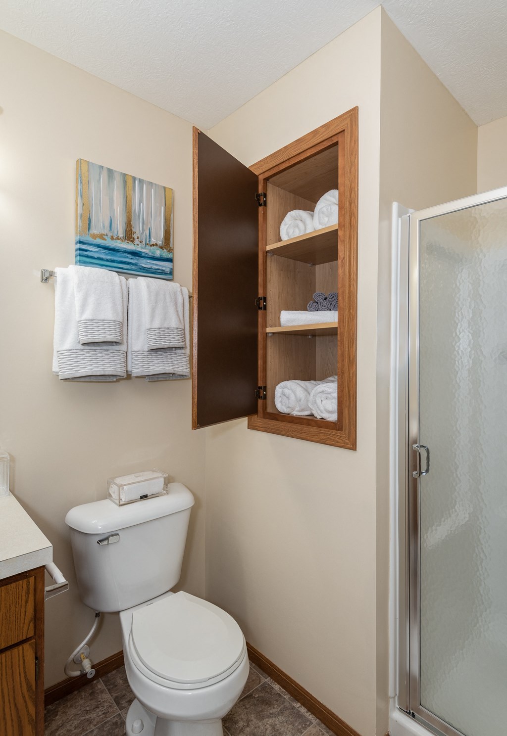 a bathroom with a toilet and a shower with a glass door