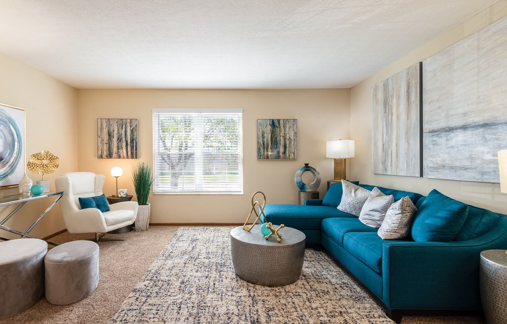 Pet-Friendly Apartments in Hilliard, OH - Residences at Breckenridge - Large Living Room with High Ceilings, Carpet Flooring, and a Window