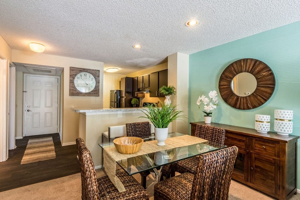 a dining room with a glass table and chairs