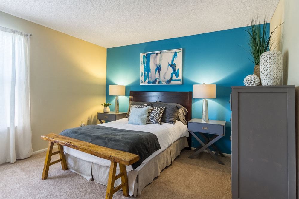 Two-Bedroom Apartments in Dublin, OH - Britton Woods - Bedroom with Two-Toned Paint, a Large Window, and Plush Carpet Flooring