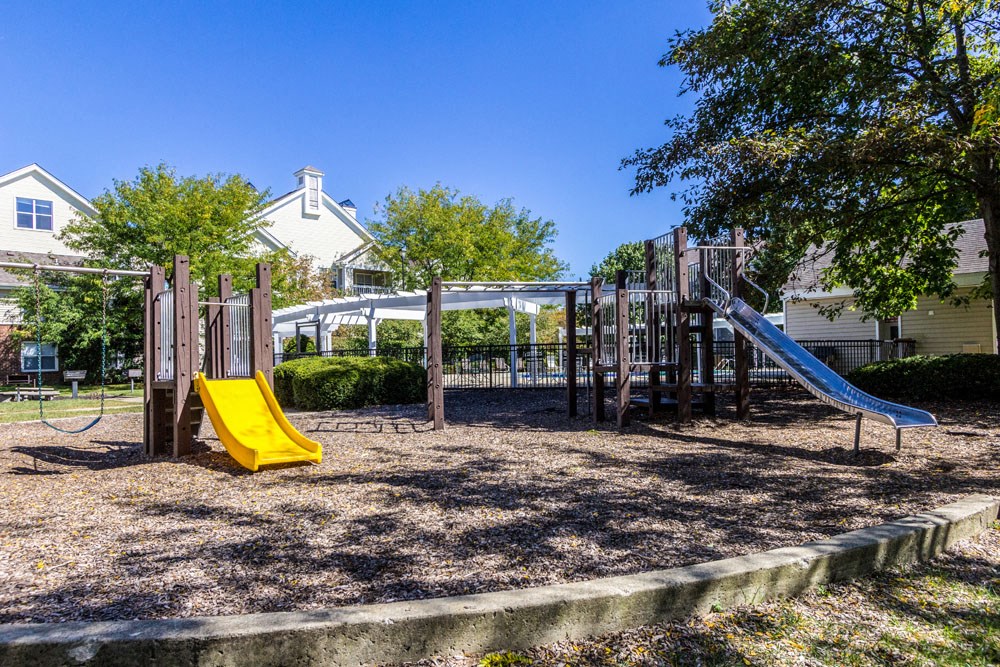 Dublin OH Apartments - Britton Woods - Playground with Slides, Climbing Equipment, and Swings.