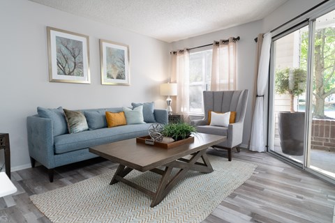 a living room with a blue couch and a coffee table