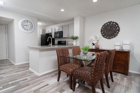 a dining room with a table and chairs and a kitchen