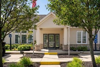 A building with a flag on top and a yellow walkway in front.
