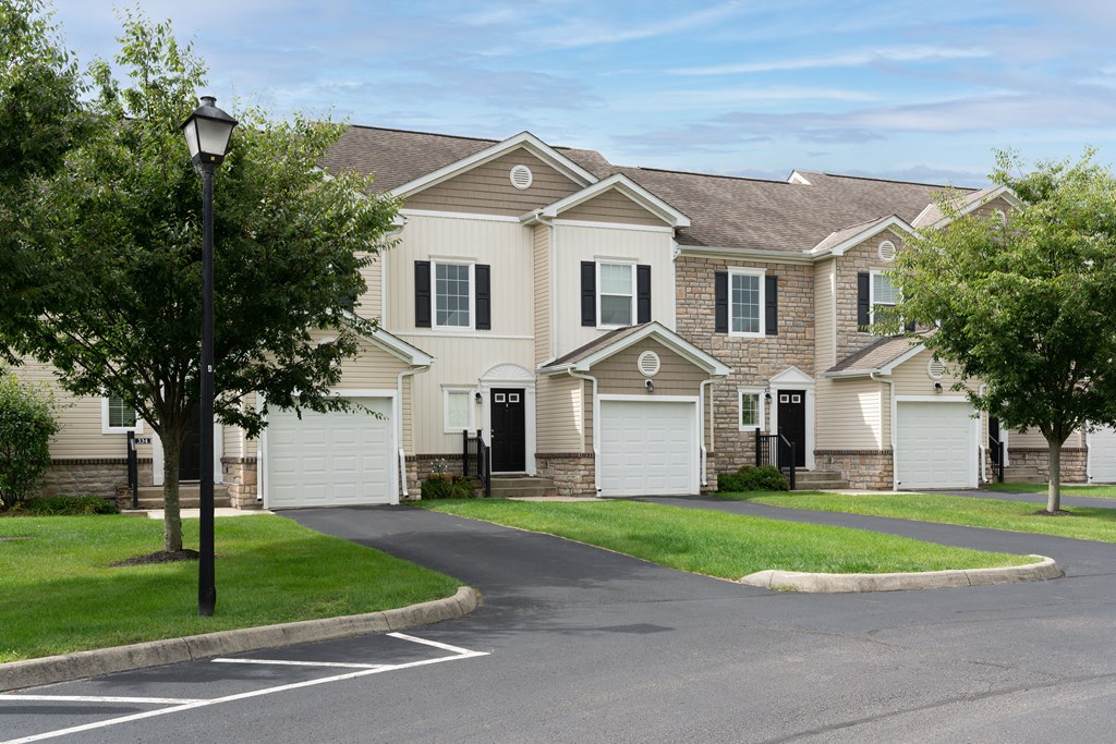 a row of houses with garages