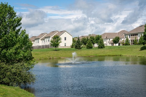 Scenic pond with a fountain, framed by Carson Farms townhomes in Delaware, OhioScenic pond with a fountain, framed by Carson Farms townhomes in Delaware, Ohio