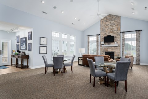 Living room at Carson Farms with a fireplace, dining table, and chairs—perfect for entertaining