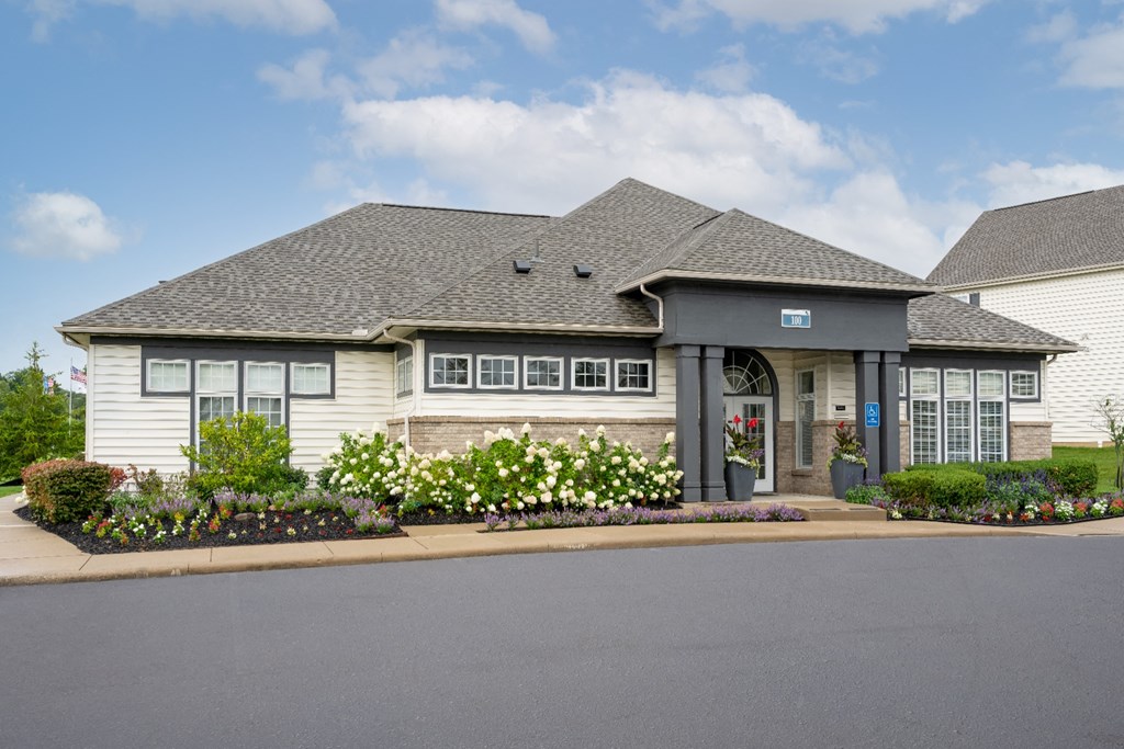 a house with white siding and a gray roof