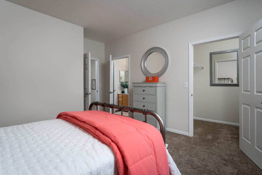 a bedroom with a bed in a room