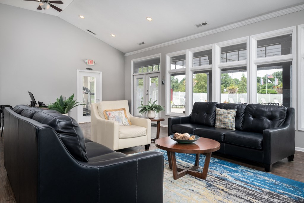 a living room filled with furniture and a large window
