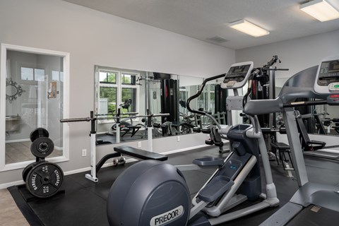 Fully equipped fitness center at Catalina Club Apartments, offering a wide range of exercise machines and workout space.