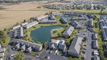 an aerial view of the campus of the university of alberta with a pond in the