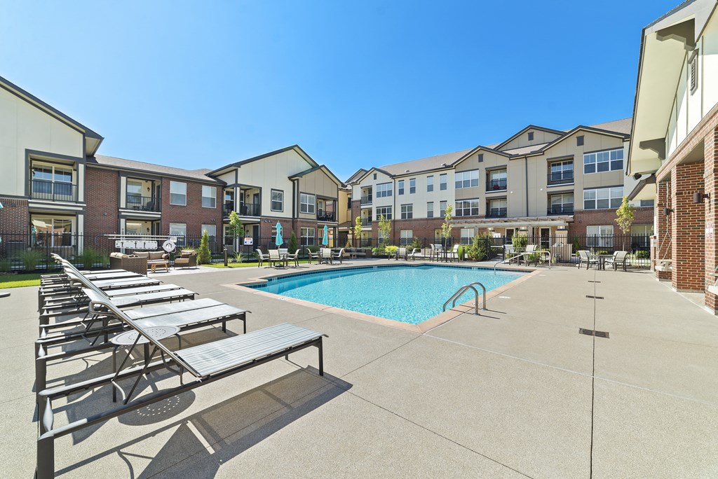 Austin Park Apartments Miamisburg Ohio Pet Friendly Amenity Resort Style Swimming Pool and Sundeck with Shaded tables and lounge chairs