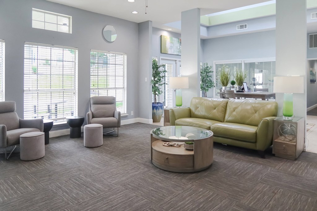 Furnished living room filled with cozy furniture and natural light from a large window