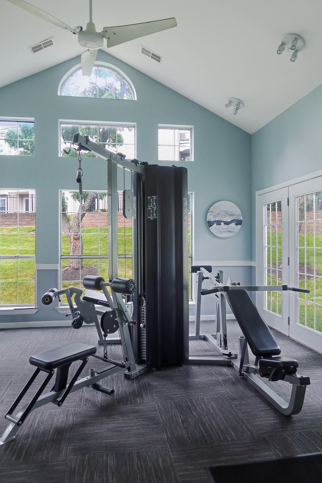 a home gym with exercise equipment and windows