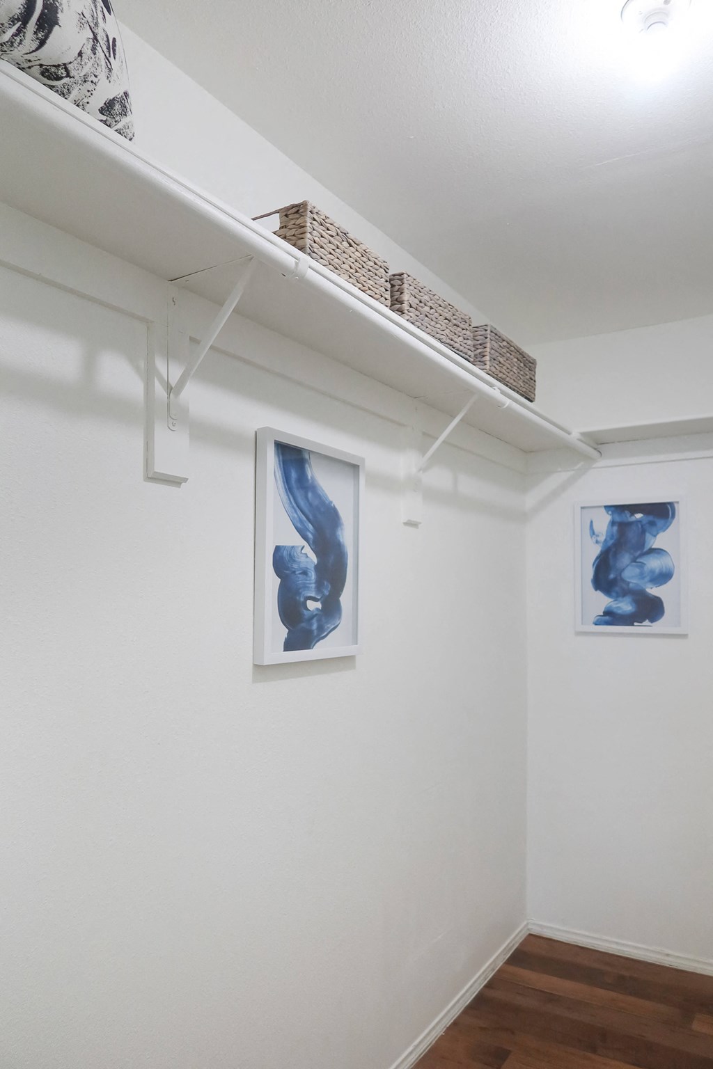 Minimalist room with white walls and abstract blue artwork