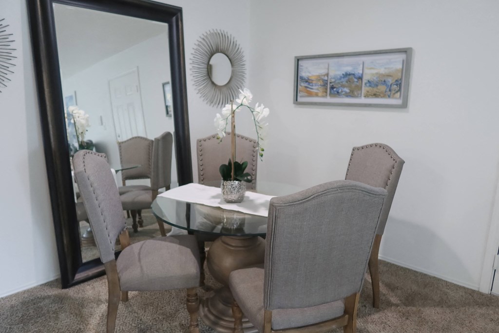 Elegant dining room with a large wall mirror and a table set for six