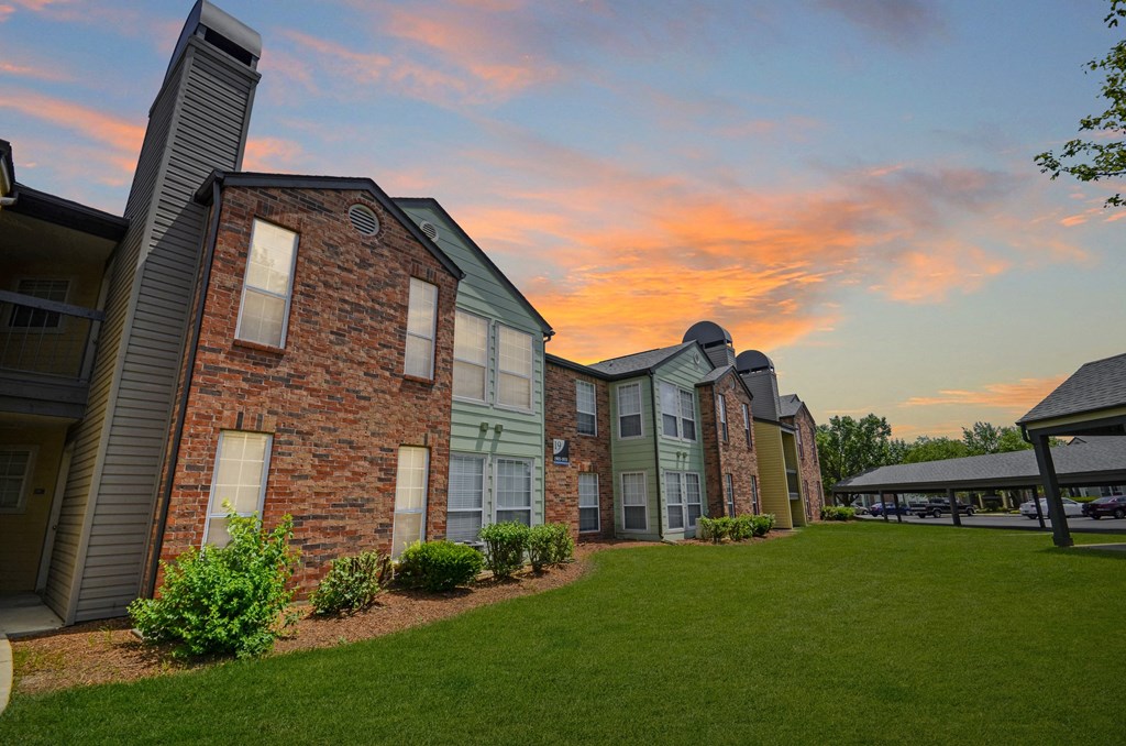 1-Bedroom Apartments in Fishers, IN - Metropolitan Fishers - Brick Apartment Building with Landscaping and Covered Parking