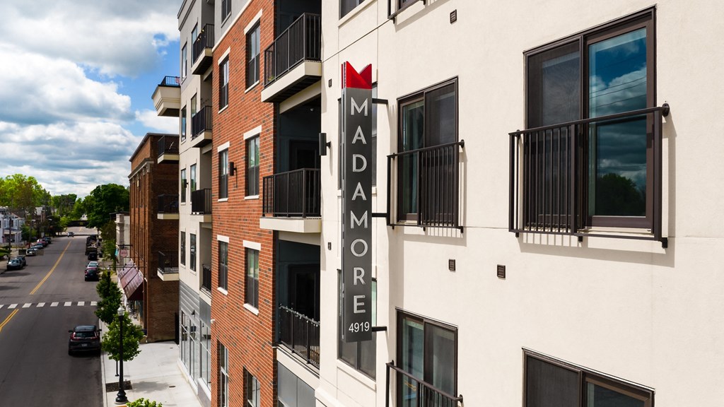Exterior shot of Madamore featuring buildings and apartment balconies.