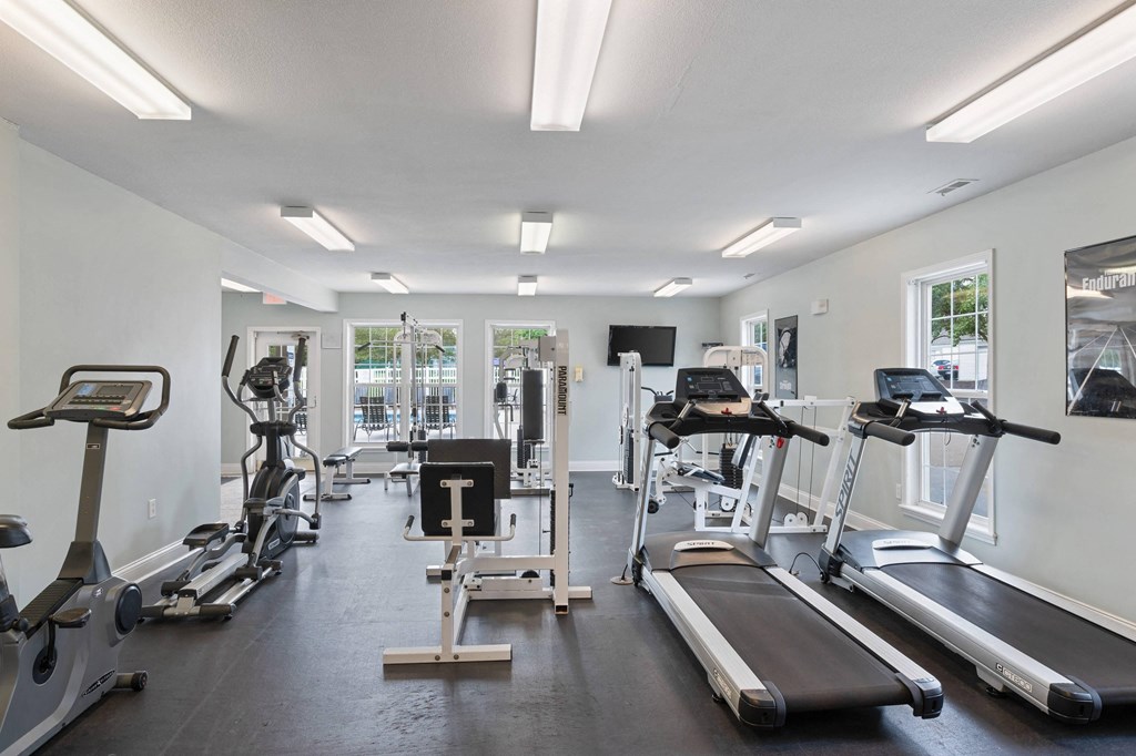 a gym with treadmills and other exercise equipment