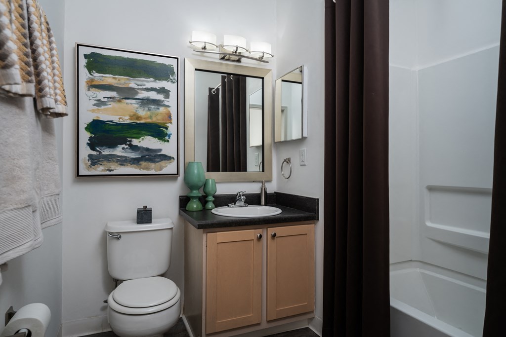 a small bathroom with a toilet sink and bathtub
