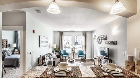 A well-lit dining area with a table set for two.