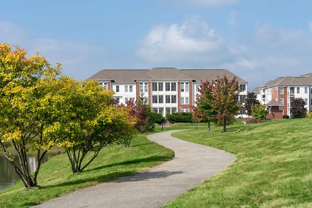 A pathway leads to a building with a grassy area on either side.