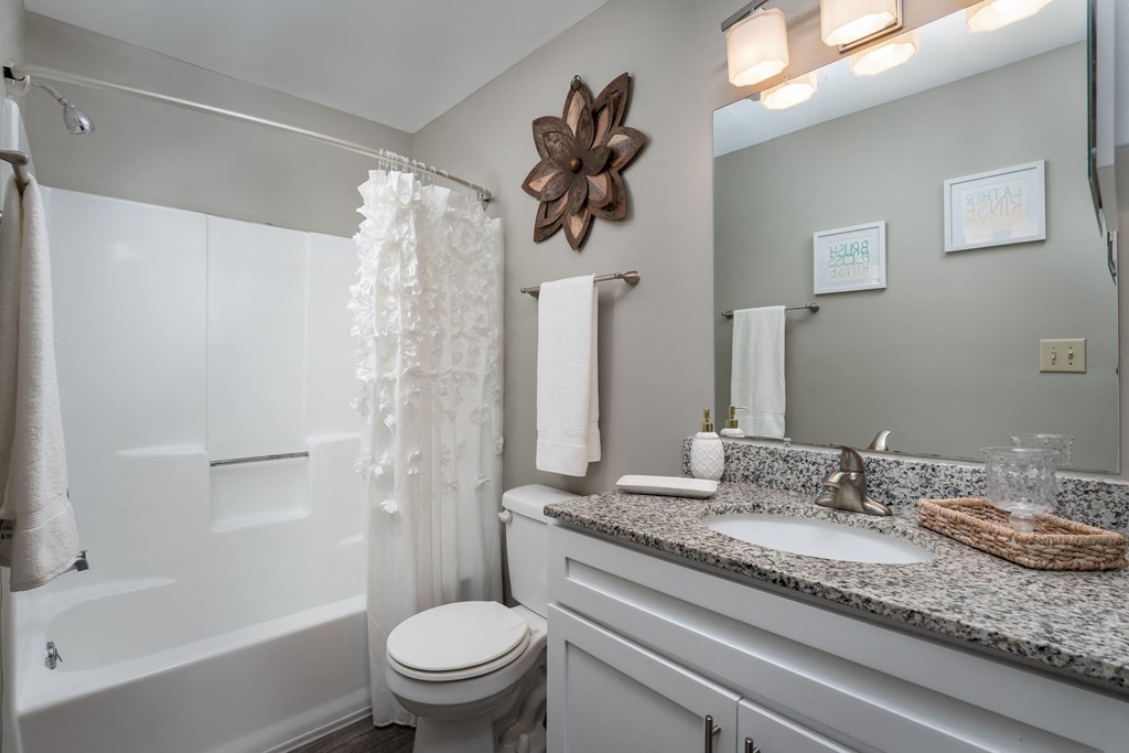 a bathroom with gray walls and a white shower curtain