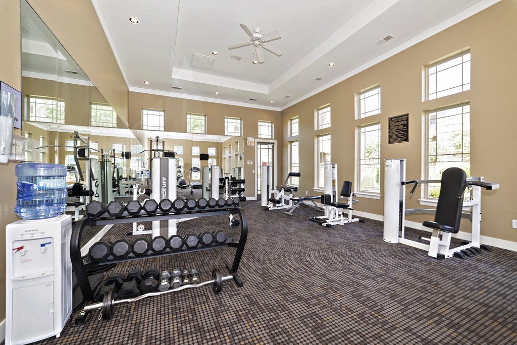 a large fitness room with treadmills and other exercise equipment