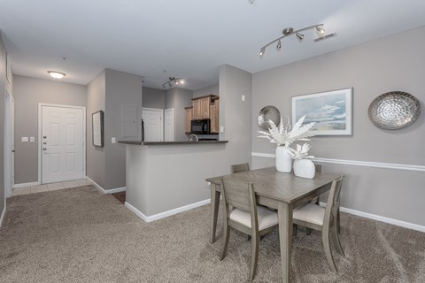 a dining room with a table and chairs and a kitchen